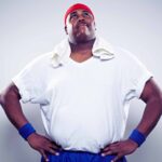 Overweight man in exercise clothing looking up post-workout.