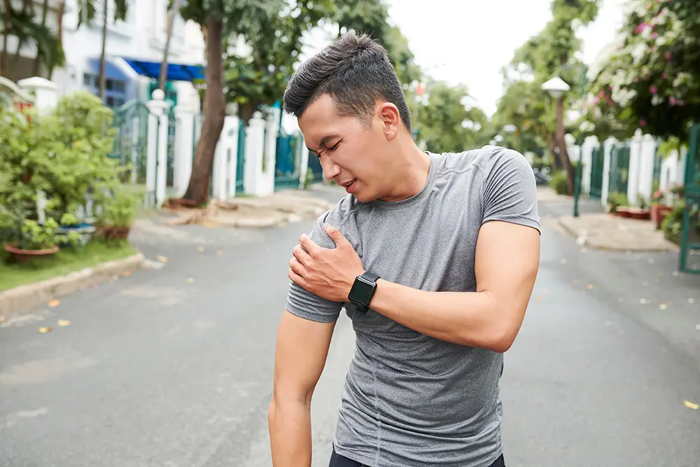 Man holding his injured shoulder